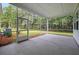 A screened porch offers a serene outdoor space with views of the lush, green backyard at 2872 Edenborough Rd, Johns Island, SC 29455