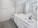 Bathroom featuring double sink vanity, tile flooring, ample lighting, and a separate shower area at 2910 John Cabot Dr, North Charleston, SC 29420