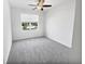 A bright bedroom featuring a window with view and neutral carpet at 2910 John Cabot Dr, North Charleston, SC 29420