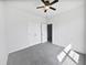 A clean, carpeted bedroom with a ceiling fan and double closet doors at 2910 John Cabot Dr, North Charleston, SC 29420