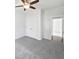 Bedroom with ceiling fan, carpet, and double closet doors at 2910 John Cabot Dr, North Charleston, SC 29420