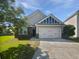 Charming single-Gathering home featuring a two-car garage, stone accents and manicured lawn on a sunny day at 2910 John Cabot Dr, North Charleston, SC 29420