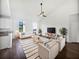 Bright living room with vaulted ceiling, ceiling fan, recessed lighting, a plush rug and comfortable seating at 2910 John Cabot Dr, North Charleston, SC 29420