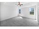 Bright main bedroom with neutral carpet, a ceiling fan, and large windows offering natural light at 2910 John Cabot Dr, North Charleston, SC 29420