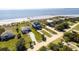 Aerial view of a beach house with a driveway and nearby waterfront at 3004 Point St, Edisto Island, SC 29438
