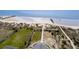 Aerial view showcasing the home and beach access with a pathway, lawns, and proximity to the ocean at 3004 Point St, Edisto Island, SC 29438