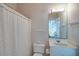Bathroom featuring a single sink vanity, toilet, and shower with curtain at 3004 Point St, Edisto Island, SC 29438