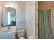 Bathroom showcasing sink, toilet, mirror, and shower with patterned wallpaper at 3004 Point St, Edisto Island, SC 29438