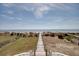 View of the beach and ocean from the top of the wooden walkway at 3004 Point St, Edisto Island, SC 29438