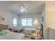 Bedroom featuring two beds, crib, rocking chair, fan, and floral accents at 3004 Point St, Edisto Island, SC 29438