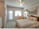 Bedroom featuring a bed with decorative pillows, chair, fan, and outside access at 3004 Point St, Edisto Island, SC 29438