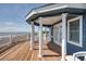 Expansive wooden deck with white pillars and ocean views at 3004 Point St, Edisto Island, SC 29438