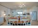 Open layout with dining table, chandelier, and staircase at 3004 Point St, Edisto Island, SC 29438