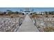 Stunning oceanfront home featuring a private boardwalk, offering direct access to the sandy beach at 3004 Point St, Edisto Island, SC 29438