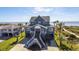 Elevated beach house with stairs, surrounded by lush greenery and palm trees, offering a tropical oasis at 3004 Point St, Edisto Island, SC 29438