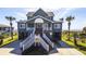 Picturesque beach house with inviting entryway, steps and stunning ocean views at 3004 Point St, Edisto Island, SC 29438