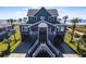 Inviting two-story beach house with a spacious driveway and lush palm trees at 3004 Point St, Edisto Island, SC 29438