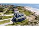 Aerial shot displaying the elegant multi-story beach house with direct beach access and serene ocean views at 3004 Point St, Edisto Island, SC 29438