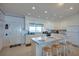 Bright kitchen with white cabinets, bar seating, and appliances at 3004 Point St, Edisto Island, SC 29438