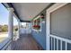 Inviting porch featuring wood floors, white railings, and outdoor seating area at 3004 Point St, Edisto Island, SC 29438