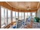 Bright sunroom with wood-paneled ceiling, walls, hardwood floors, and ocean views at 3004 Point St, Edisto Island, SC 29438