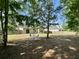 Fenced backyard with lawn and patio area with umbrella table set, perfect for outdoor enjoyment at 3006 Central Ring Ct, Ridgeville, SC 29472