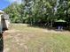 Spacious backyard with an established lawn, mature trees, and a privacy fence at 3006 Central Ring Ct, Ridgeville, SC 29472
