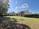 Expansive backyard featuring lush grass, a privacy fence, and mature trees at 3006 Central Ring Ct, Ridgeville, SC 29472