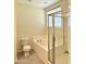 Neat bathroom featuring a shower with glass doors, a tub, and a toilet at 3006 Central Ring Ct, Ridgeville, SC 29472