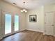 Bright dining area features wood floors, modern lighting, and sliding glass doors to let the light shine in at 3006 Central Ring Ct, Ridgeville, SC 29472