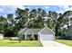Charming single-Gathering home with a well-maintained lawn, a two-car garage, and mature trees in the background at 3006 Central Ring Ct, Ridgeville, SC 29472