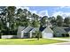 Cozy home with a well-kept lawn, inviting curb appeal and a driveway leading to an attached garage at 3006 Central Ring Ct, Ridgeville, SC 29472