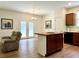 Open floorplan showcasing a kitchen island and a sitting area with access to a outdoor patio at 3006 Central Ring Ct, Ridgeville, SC 29472