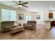 Spacious living room with wood floors, ceiling fan, and seamless flow into the kitchen at 3006 Central Ring Ct, Ridgeville, SC 29472