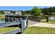 Picturesque community pond with a wooden bridge, lush greenery, and tranquil surroundings at 3006 Central Ring Ct, Ridgeville, SC 29472