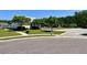 Community clubhouse and pool area with mature trees, pool chairs, and paved walkways at 3006 Central Ring Ct, Ridgeville, SC 29472