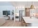 Open kitchen featuring a large island, stainless steel refrigerator, and modern pendant lighting at 311 Papa Charlie Way, Charleston, SC 29412