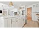 Close-up of the kitchen island showcasing the stainless steel dishwasher and white farmhouse sink at 311 Papa Charlie Way, Charleston, SC 29412