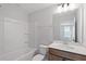 Clean, white bathroom with tub, modern fixtures and wood-tone vanity at 314 O'Malley Dr, Summerville, SC 29483