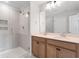 Bathroom featuring double sinks, wood cabinets, and a glass enclosed tiled shower at 314 O'Malley Dr, Summerville, SC 29483