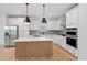 Modern kitchen features white cabinetry, stainless steel appliances, quartz countertops, and a stylish island at 314 O'Malley Dr, Summerville, SC 29483