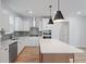 Well-lit kitchen with stainless steel appliances, white cabinets, subway tile backsplash, and island at 314 O'Malley Dr, Summerville, SC 29483