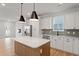 Bright kitchen boasts an island, stainless appliances, white cabinets, and a modern design at 314 O'Malley Dr, Summerville, SC 29483