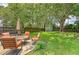 Spacious backyard with lush green grass, mature trees, patio furniture, and a storage shed at 4587 Durant Ave, North Charleston, SC 29405