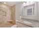 Bathroom featuring tiled shower with built-in shelves, granite countertop, and ample lighting at 4587 Durant Ave, North Charleston, SC 29405