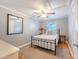Cozy bedroom features a metal frame bed, ceiling fan, and a neutral color palette with a decorative mirror at 4587 Durant Ave, North Charleston, SC 29405