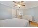 Bright bedroom with hardwood floors, a ceiling fan, and a glimpse into the living room through an open doorway at 4587 Durant Ave, North Charleston, SC 29405