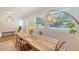 Inviting dining area with a wooden table, abundant natural light, and stylish lighting fixtures at 4587 Durant Ave, North Charleston, SC 29405