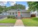 Charming single-story home with a landscaped front yard and a welcoming pink front door at 4587 Durant Ave, North Charleston, SC 29405