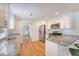 Well-lit kitchen with white cabinets, granite countertops, stainless steel appliances, and hardwood floors at 4587 Durant Ave, North Charleston, SC 29405